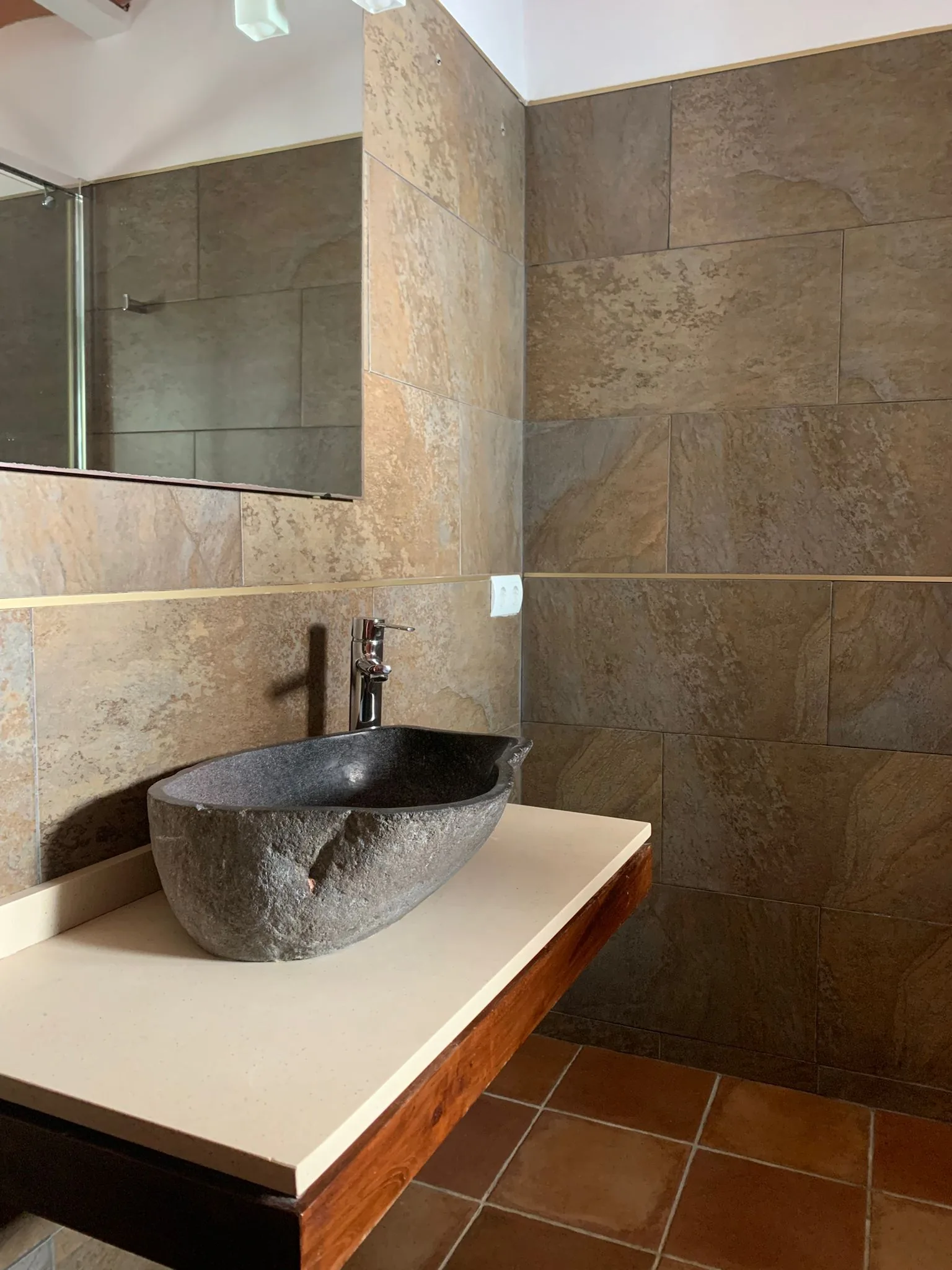 Stone bathroom sink with natural materials — private bathroom Ibiza finca