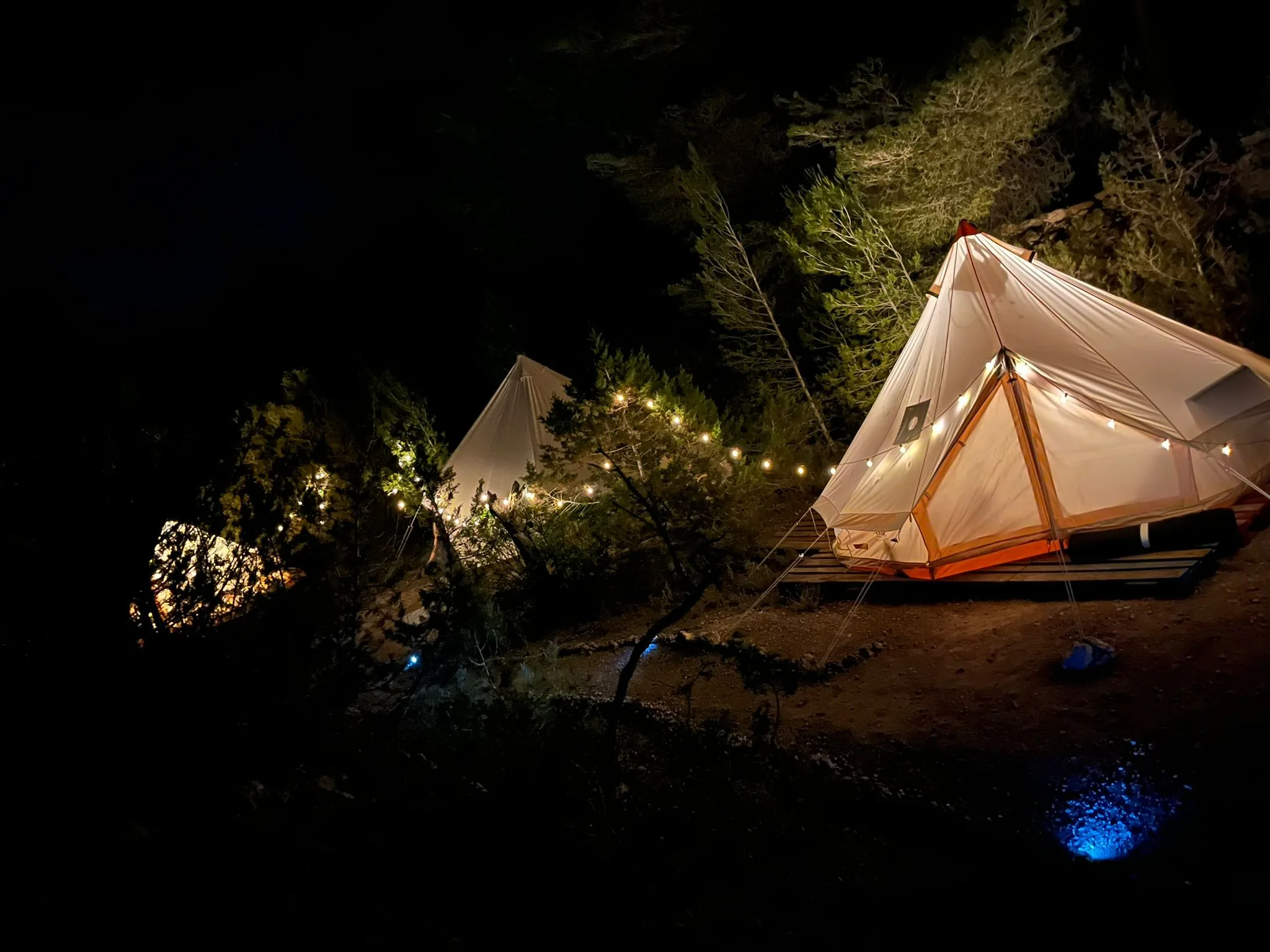 Glamping bell tents glowing with fairy lights at night — Ibiza glamping La Casa de Mis Sueños
